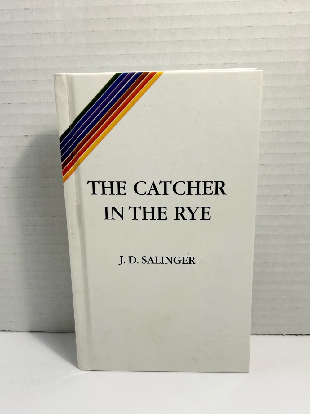 The Catcher in the Rye by J. D. Salinger - White Hard Cover with Rainbow Accent